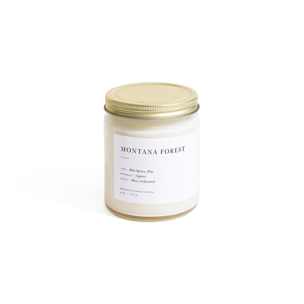 Montana Forest jar candle with gold lid and white label on white background
