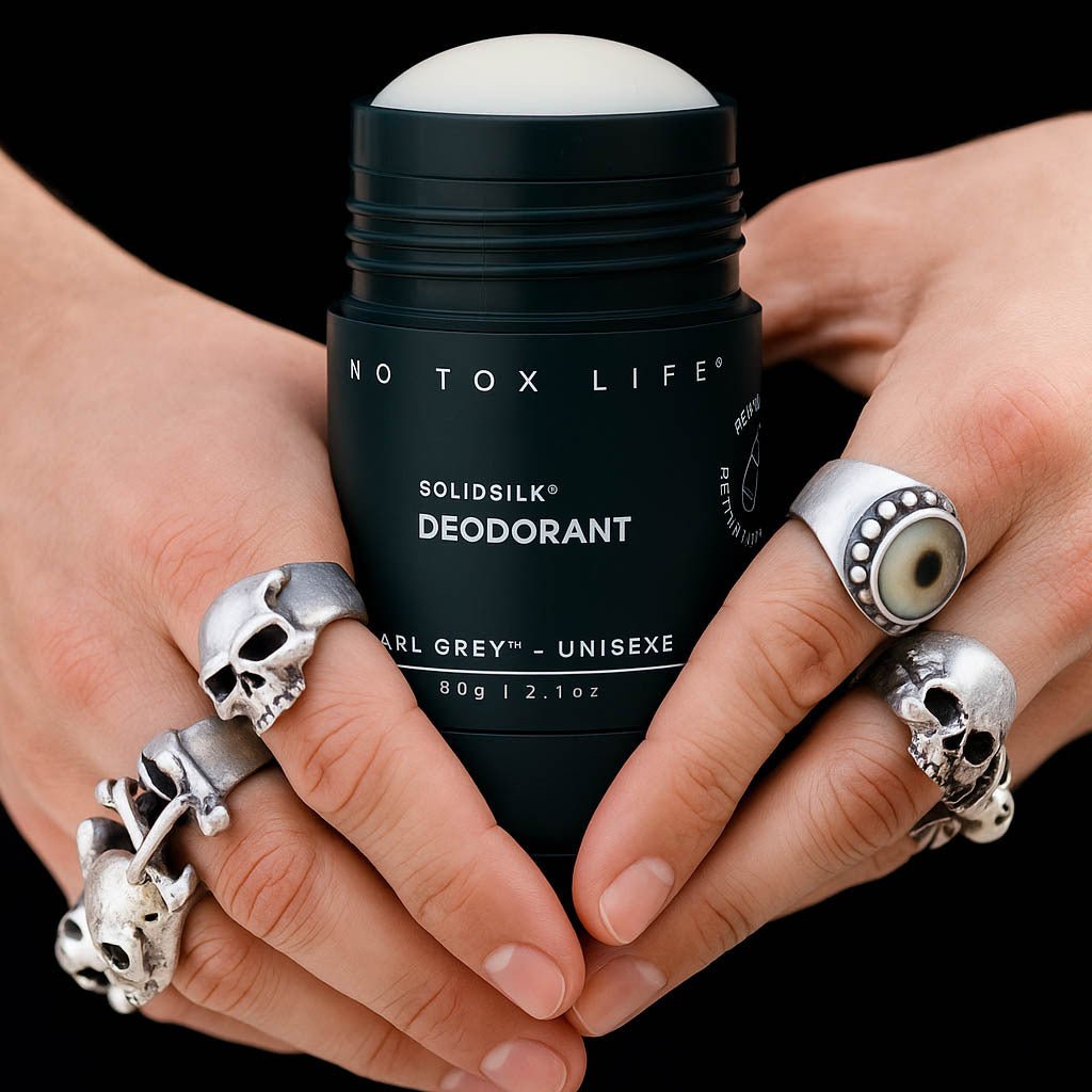 Hands holding an open tube of deodorant.