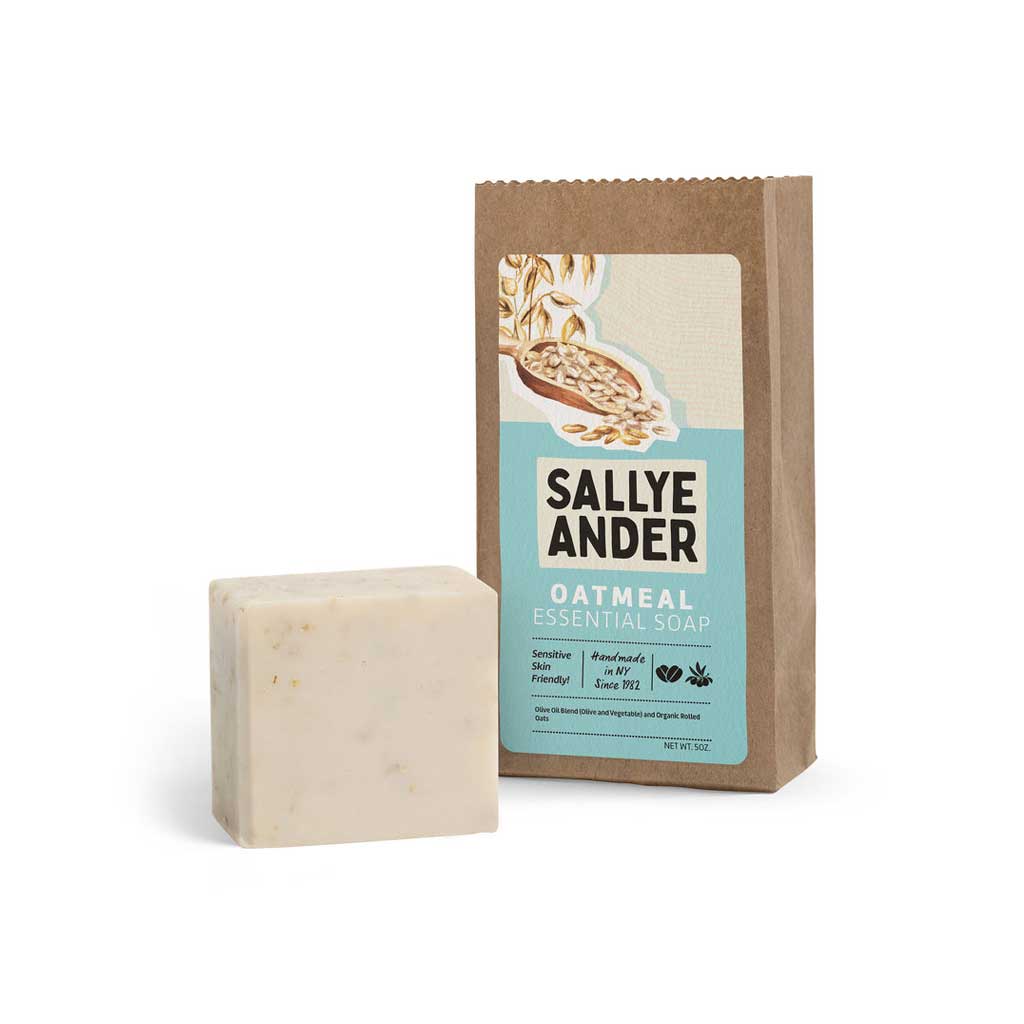 Bar of SallyeAnder unscented oatmeal essential soap on white background next to packaging