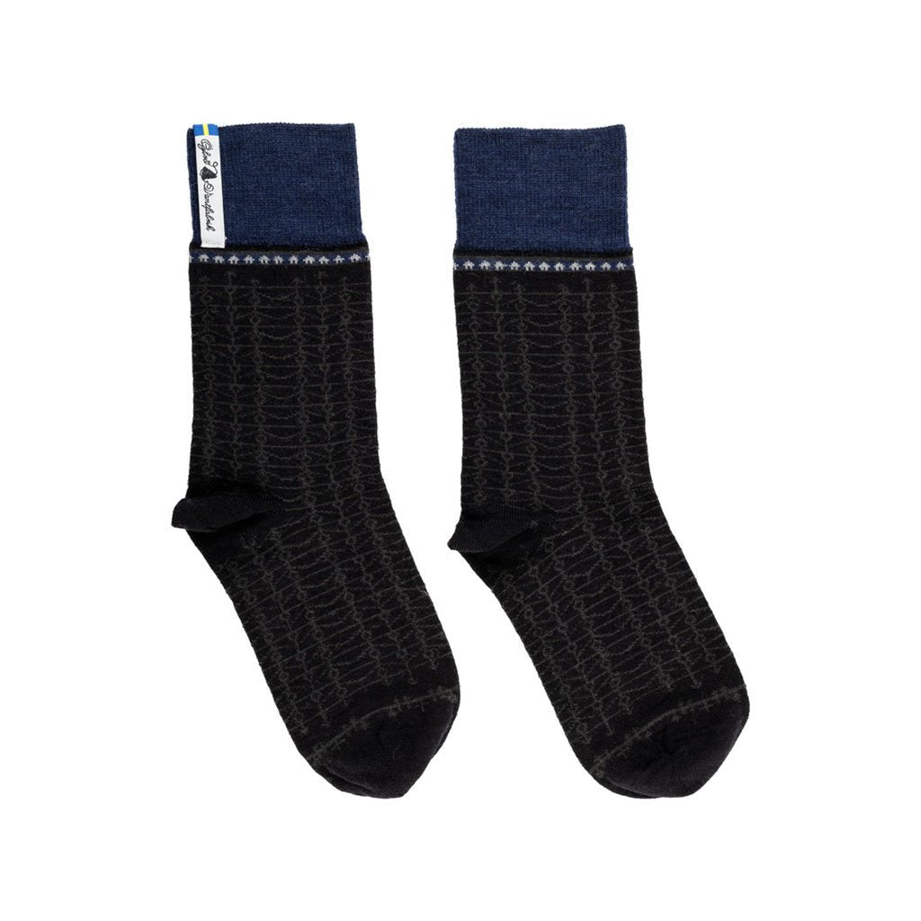 A pair of blue and black patterned merino wool socks.