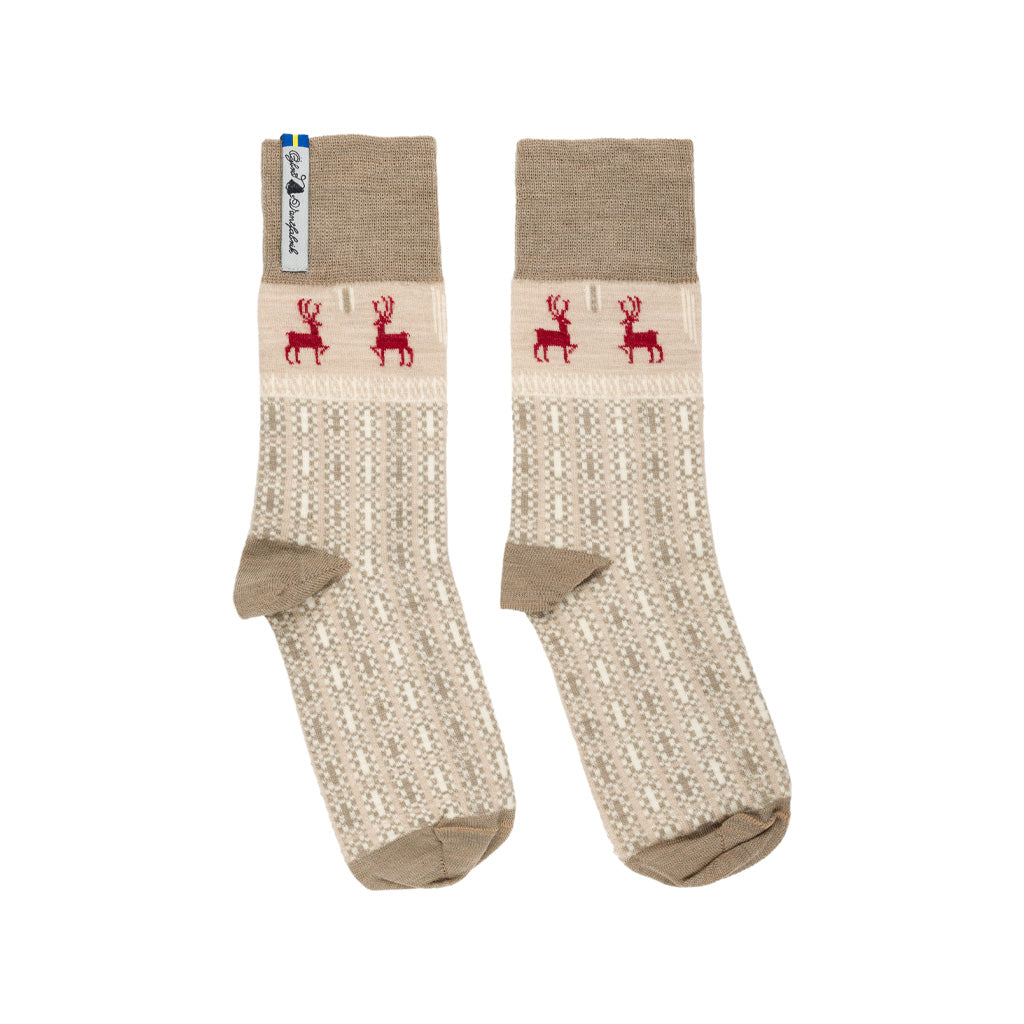 A pair of beige and red patterned merino wool socks.