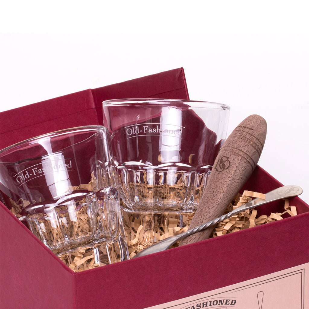 Two Old Fashioned glasses with a muddler and spoon in a red gift box.
