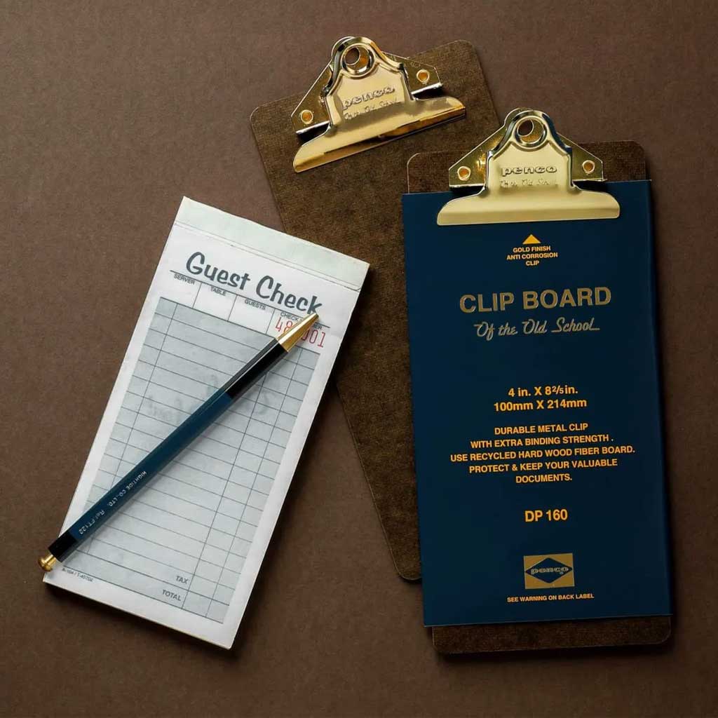 Clipboard with guest check and pen on a brown background