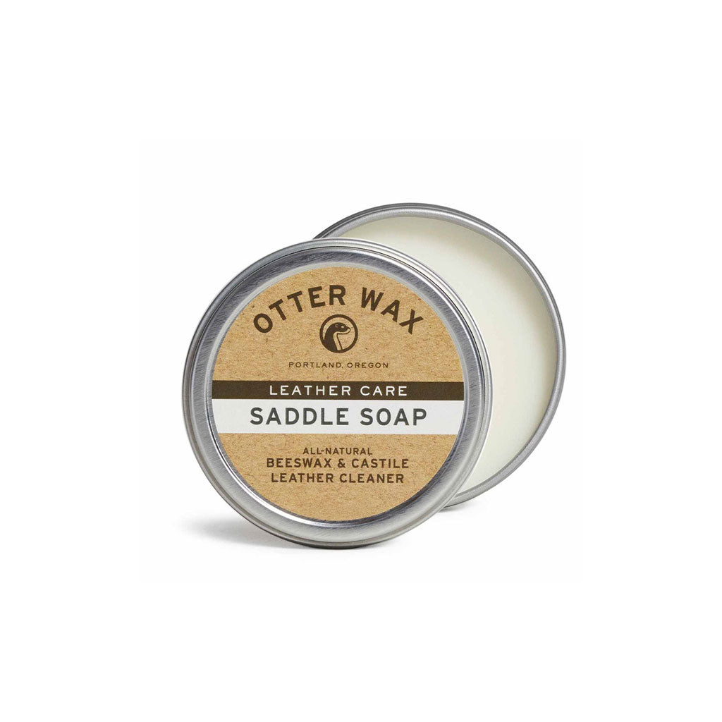A round tin of Otter Wax Saddle Soap. The lid is ajar, showing smooth white soap inside.