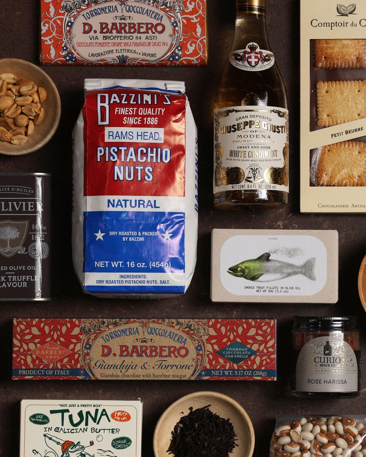 Assorted pantry staples and snacks arranged on a dark surface.