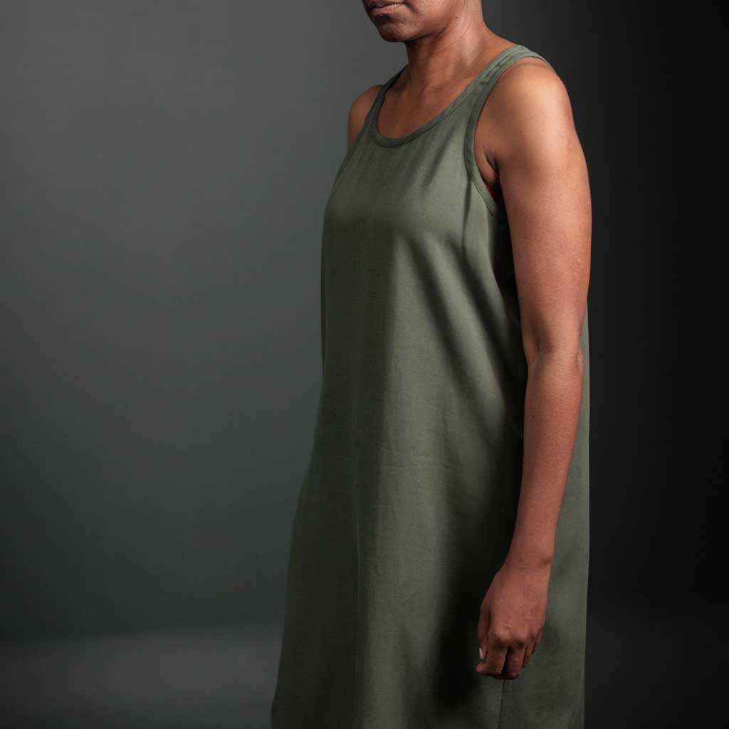 Woman wearing merchant and mills sewn clothing against dark background