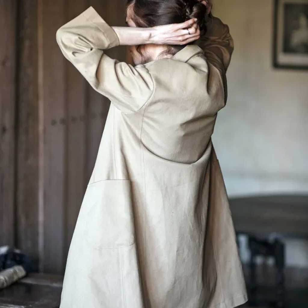 Woman wearing merchant and mills sewn clothing against light background