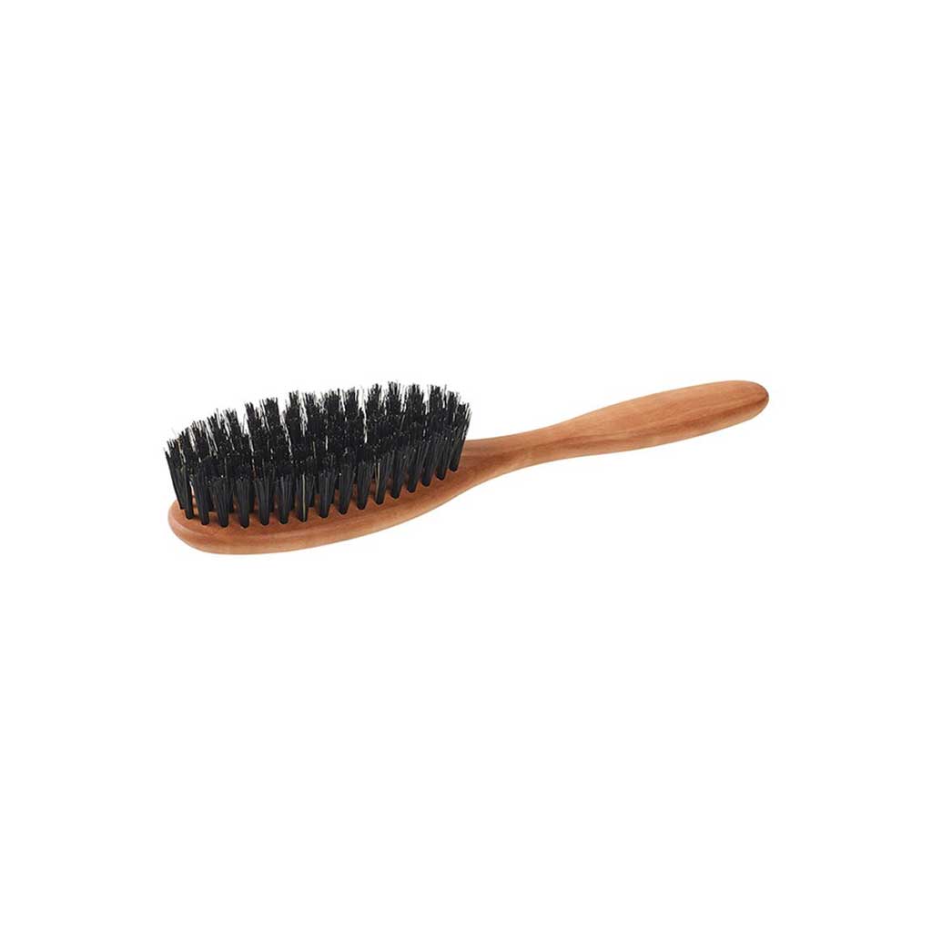 Small pear wood hairbrush with dark boar bristles on white background