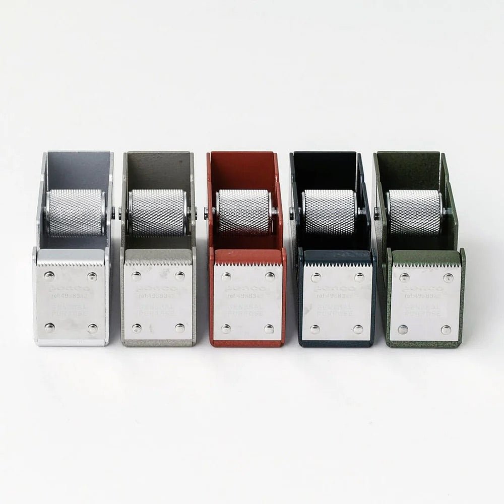 Set of five metal desk tape dispensers in different colors on a white background