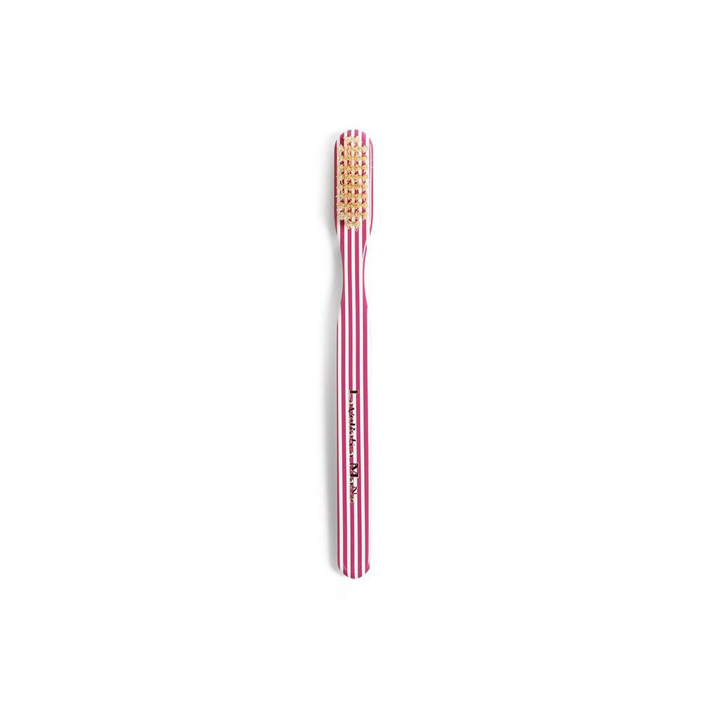 Purple striped toothbrush on white background