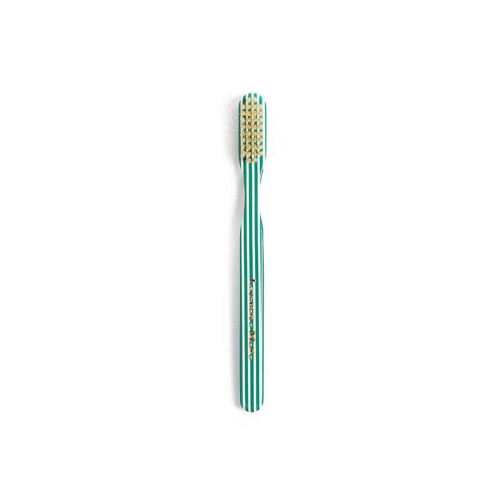 Green striped toothbrush on white background