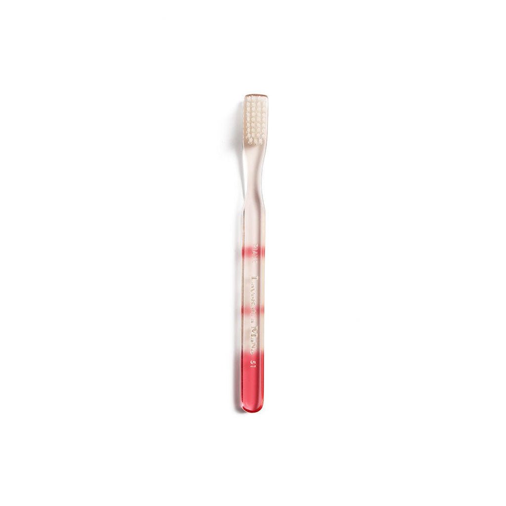 Red and clear toothbrush with gradient color handle on a white background