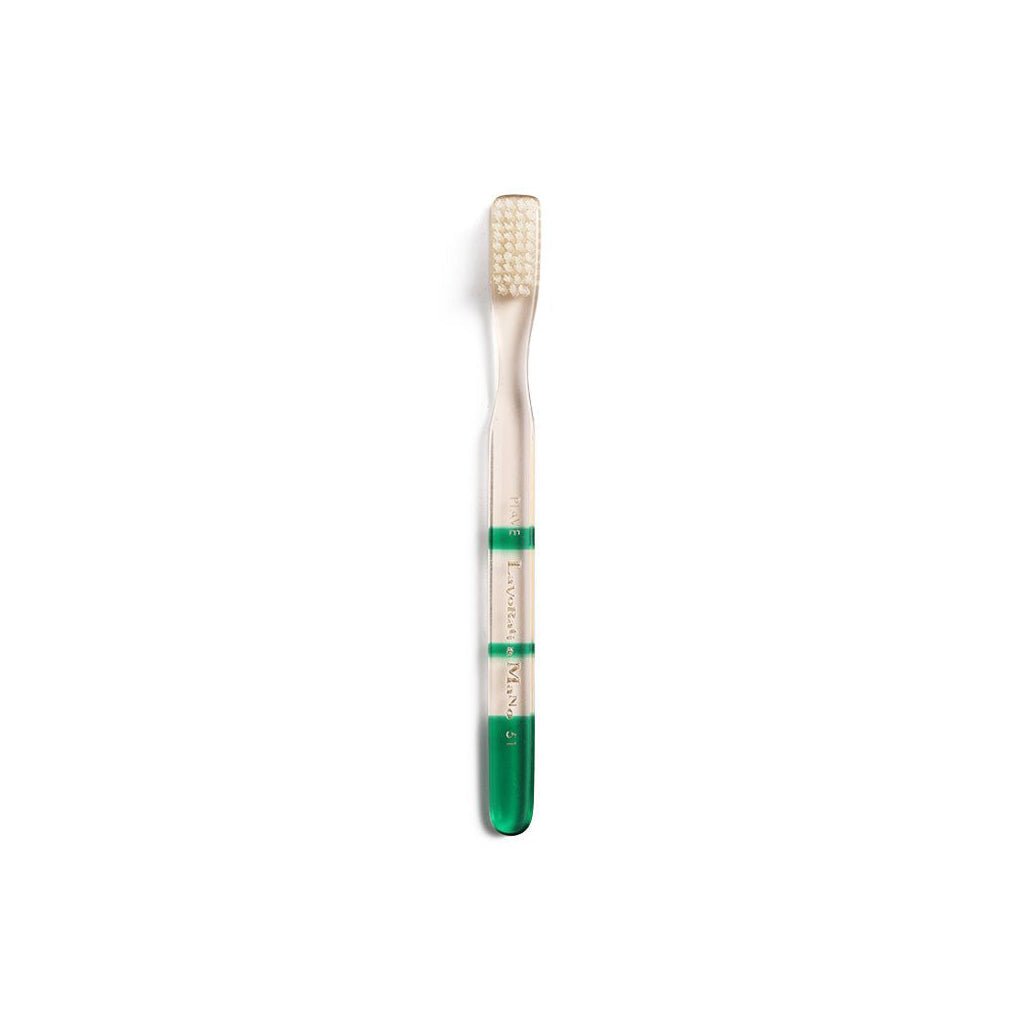 Green and clear toothbrush with gradient color handle on a white background