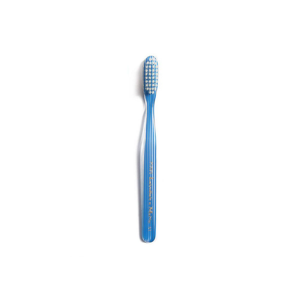 Blue and clear striped toothbrush on white background