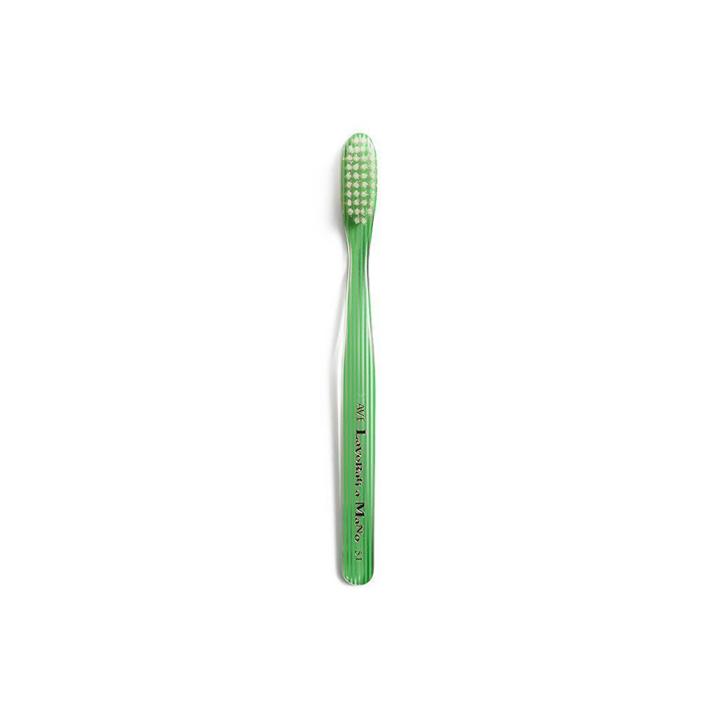 Green and clear striped toothbrush on white background