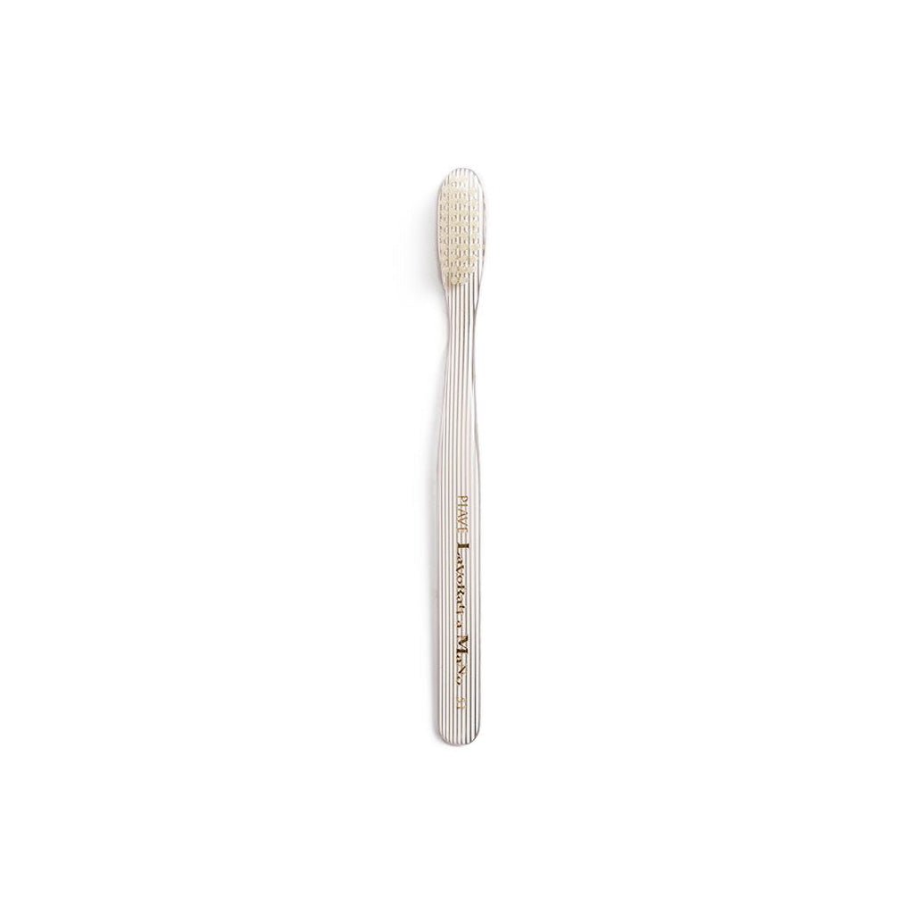 White and clear striped toothbrush on white background