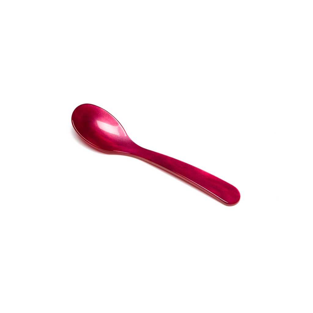 Raspberry pink acrylic egg spoon on white background