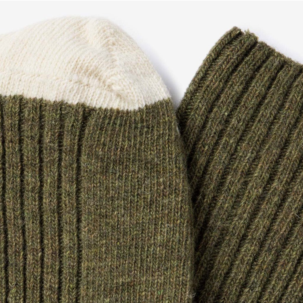 Close-up of green and cream colored wool socks.