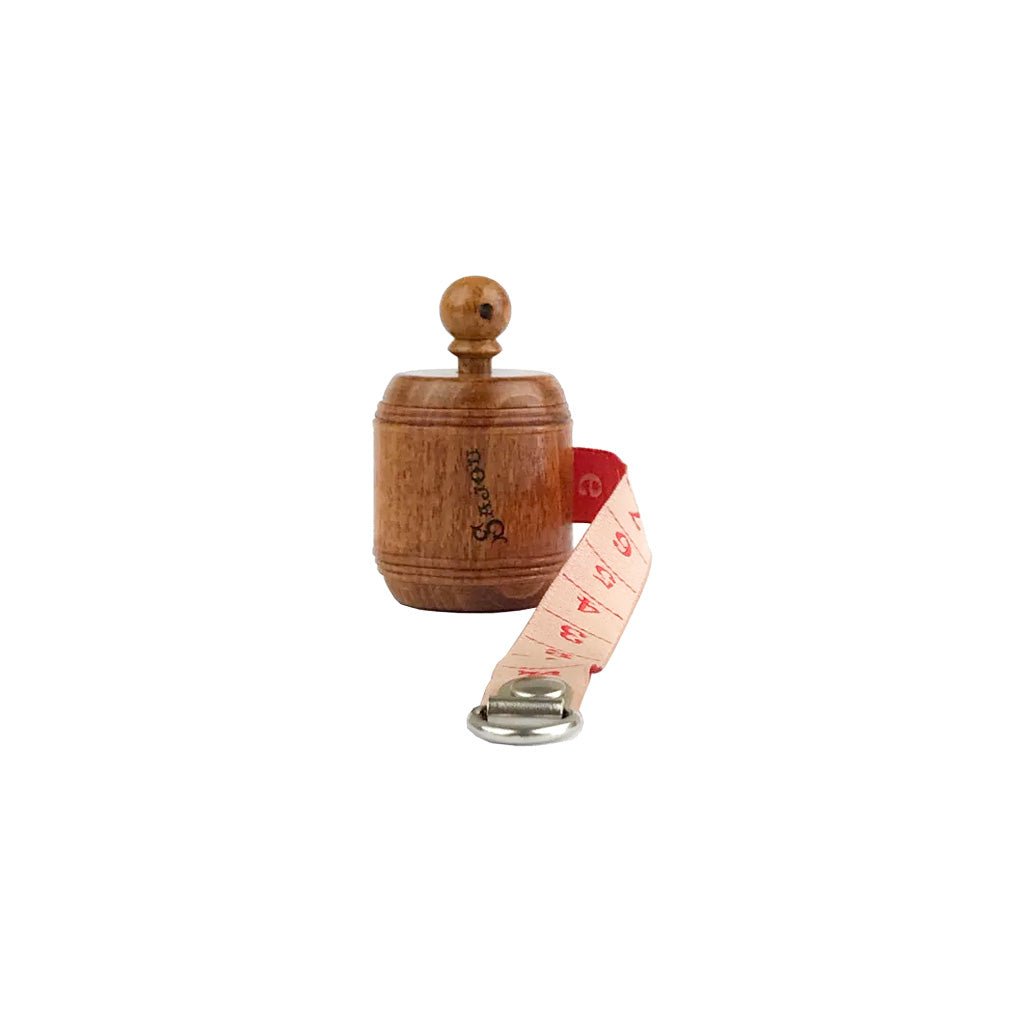 Wooden measuring tape with red ribbon open on white background.