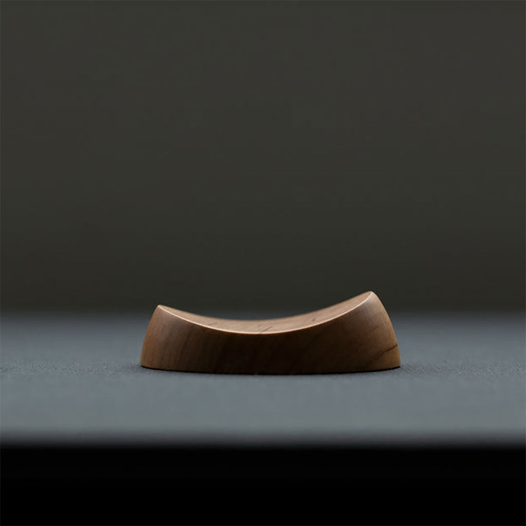 Wooden pen rest on dark background
