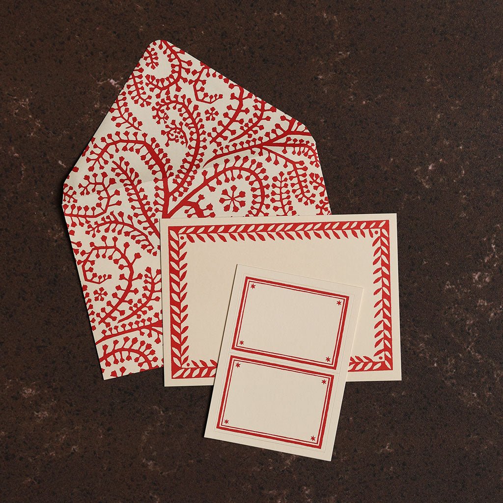 Red and white patterned cards on a dark brown surface