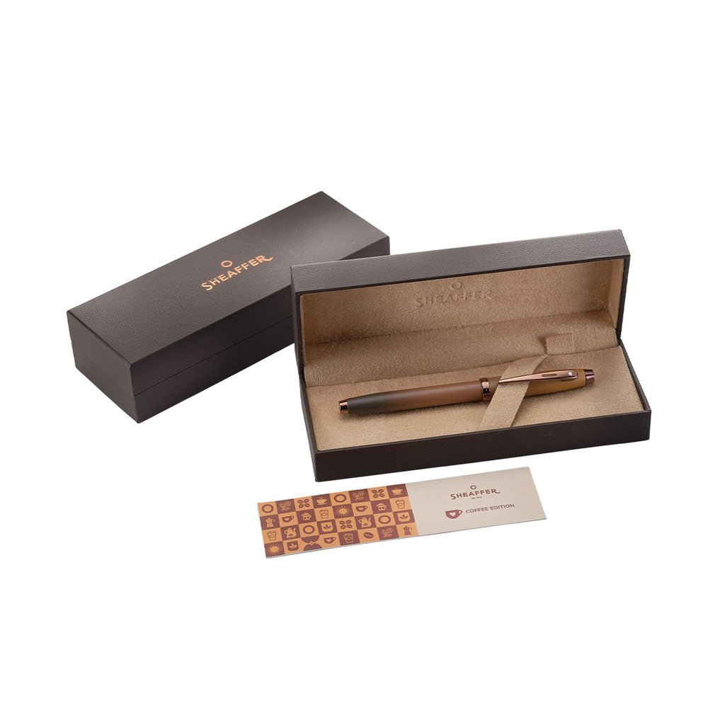 Sheaffer pen in an open box with a business card on a white background