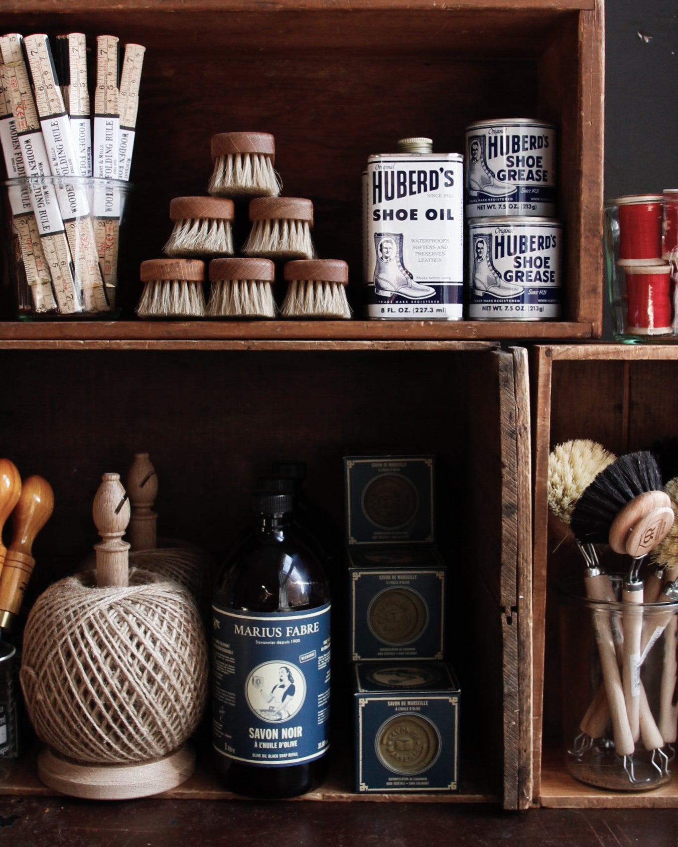 Assorted tools and household essentials arranged in wooden cubbies.