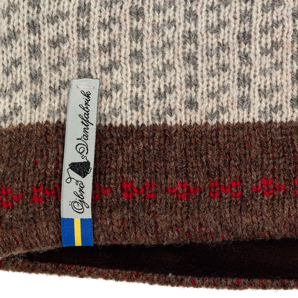 Close-up of a patterned fabric with a brand label on a white background