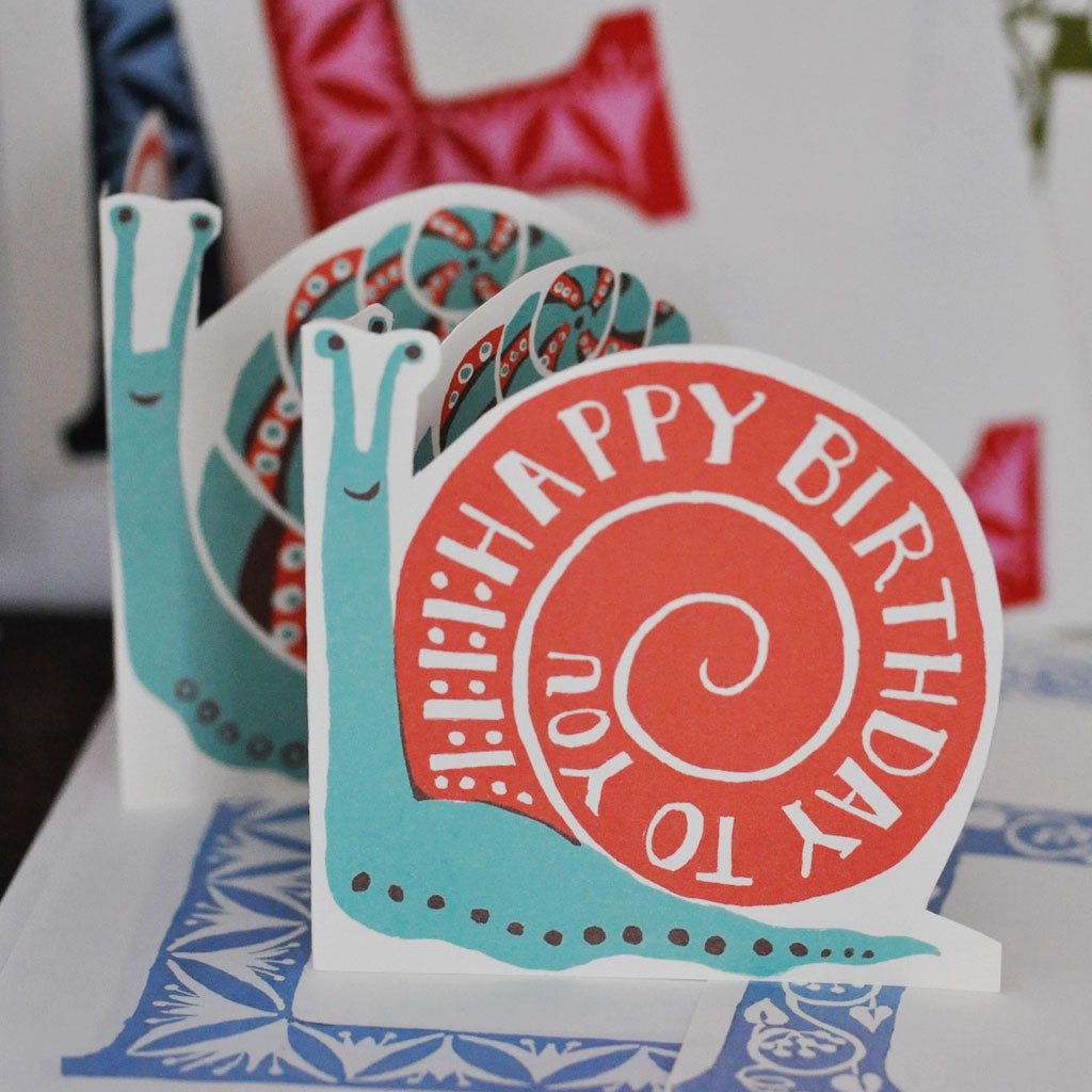 Snail-shaped birthday card with text that reads happy birthday to you
