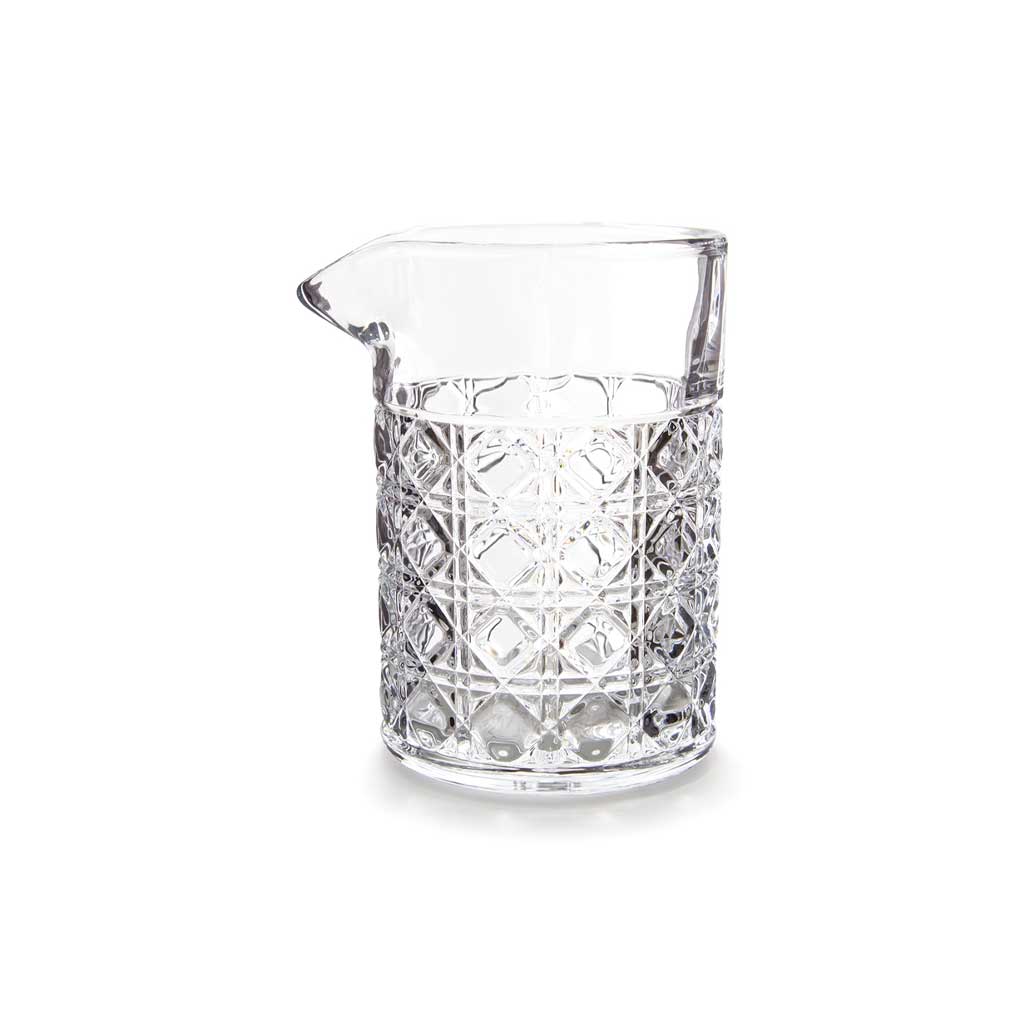 Clear mixing glass with geometric pattern on white background