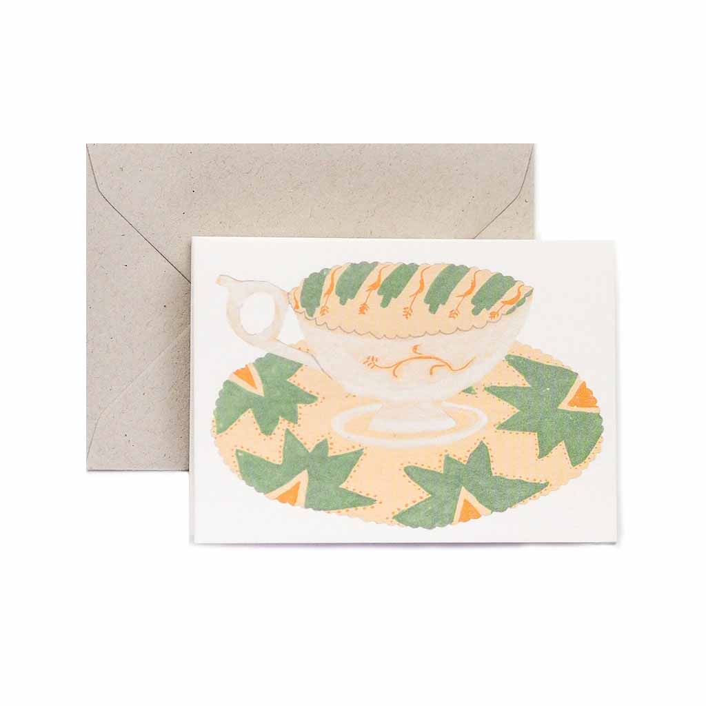 Card with a teacup design and envelope on a white background