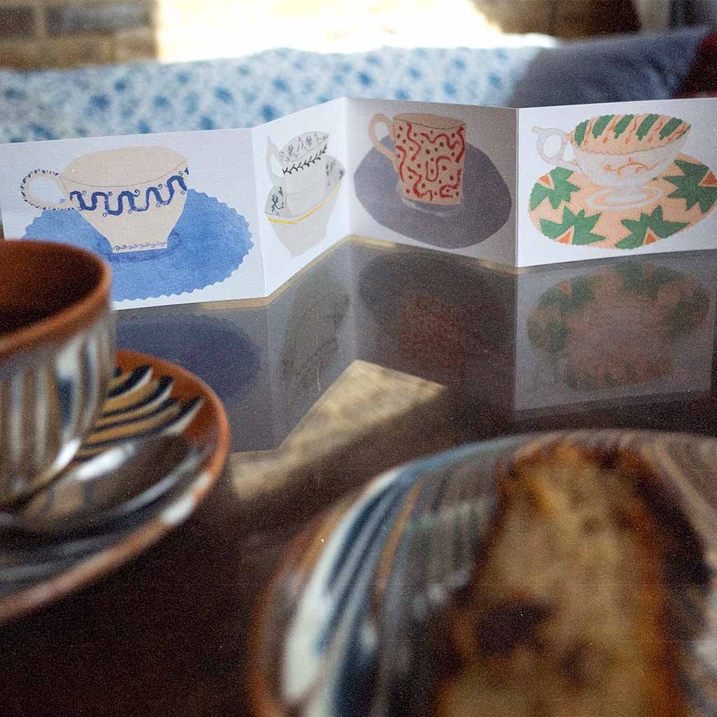 Teacups and Saucers card standing upright on table