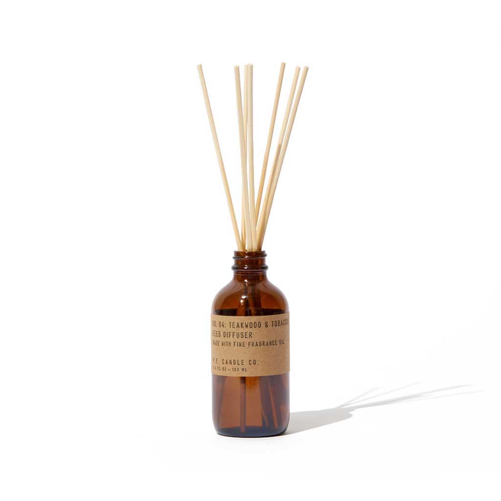 Brown diffuser bottle with wooden sticks on a white background