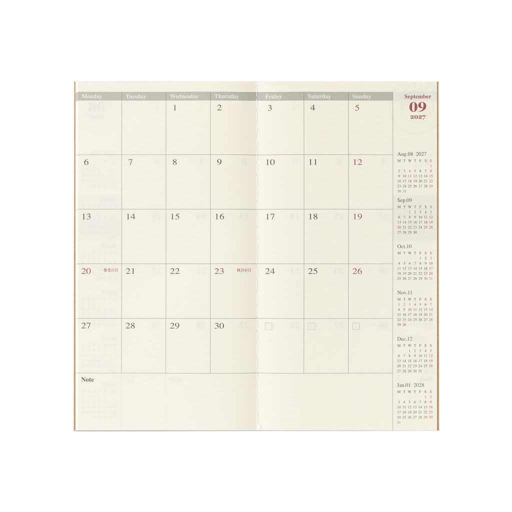 An open Traveler's Notebook refill with monthly calendar page on white background
