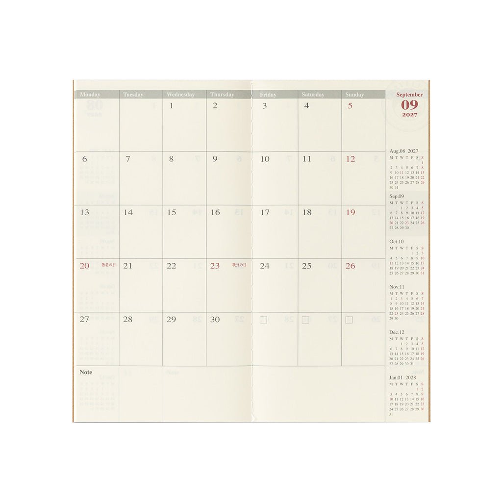 An open Traveler's Notebook refill with monthly calendar page on white background