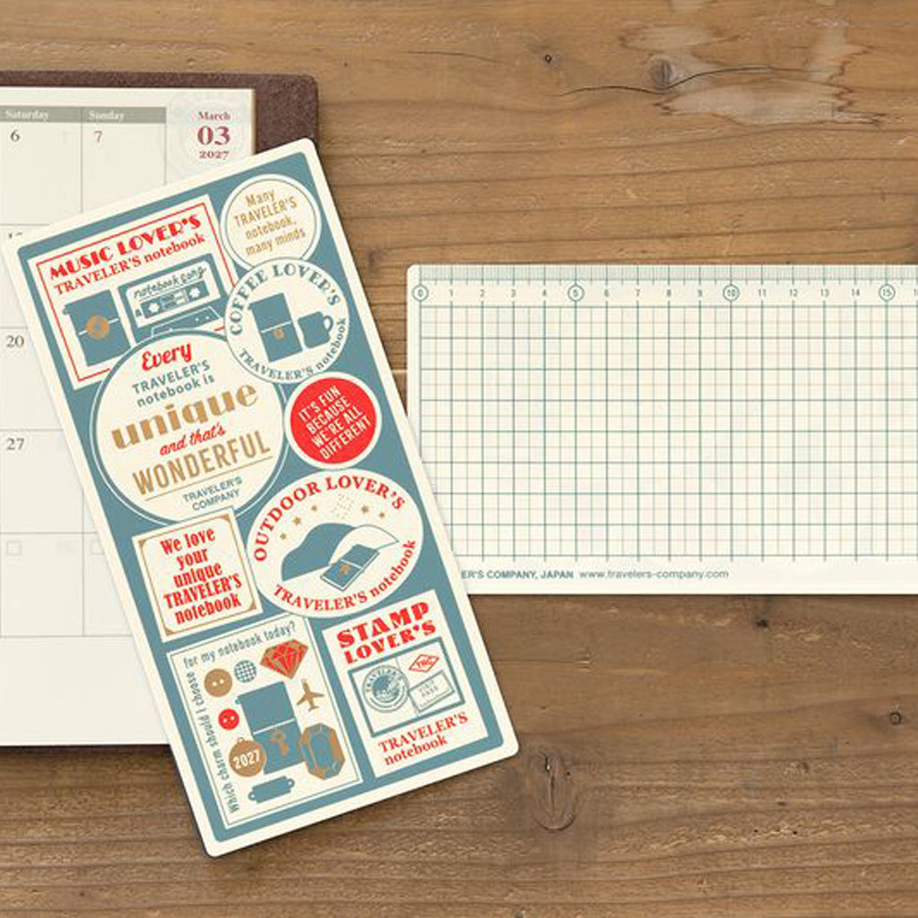 Traveler's Notebook plastic sheet board next to notebook on wooden table