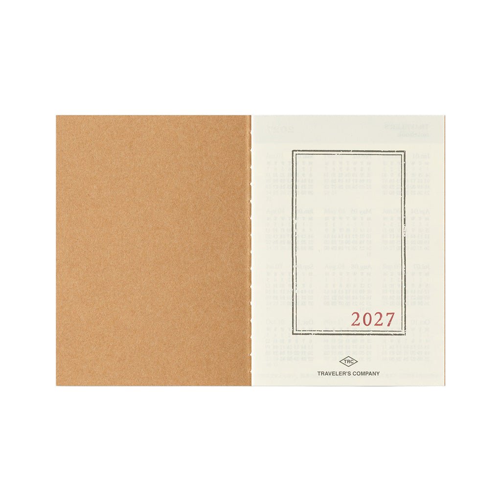An open Traveler's Passport Notebook refill for 2027 on white background