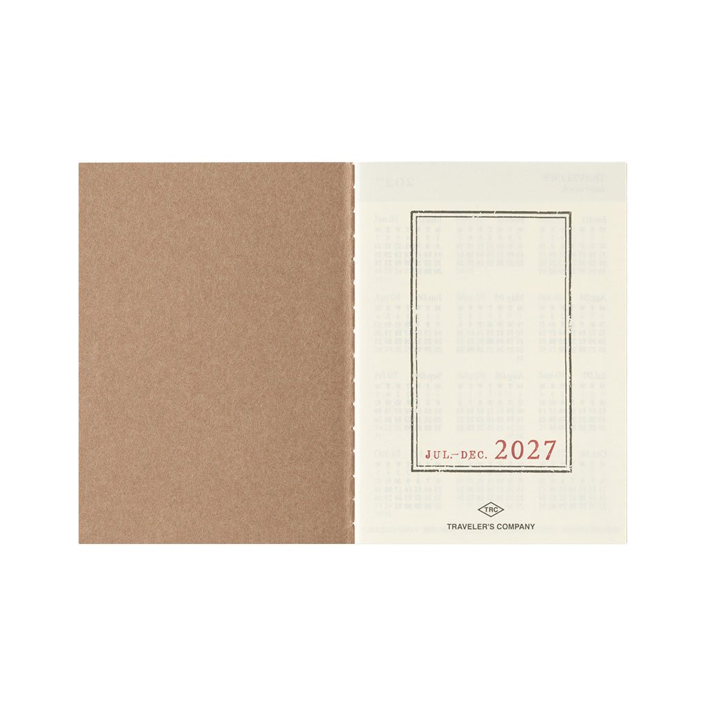 An open Traveler's Notebook passport size Diary 2027 Weekly refill with July through December cover page on white background