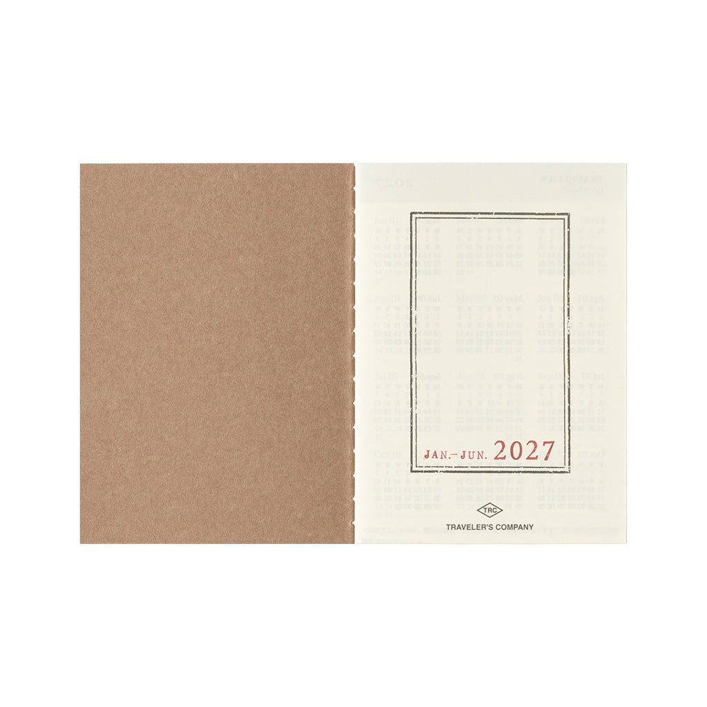 An open Traveler's Notebook passport size Diary 2027 Weekly refill with January through June cover page on white background