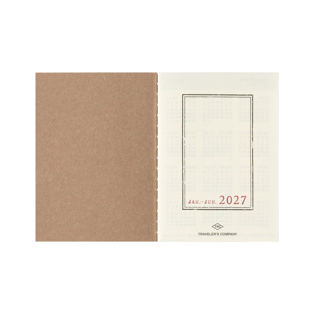 An open Traveler's Notebook passport size Diary 2027 Weekly refill with January through June cover page on white background