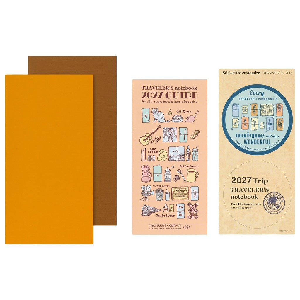 Two orange Traveler's Notebook refills with 2027 Diary guide on white background