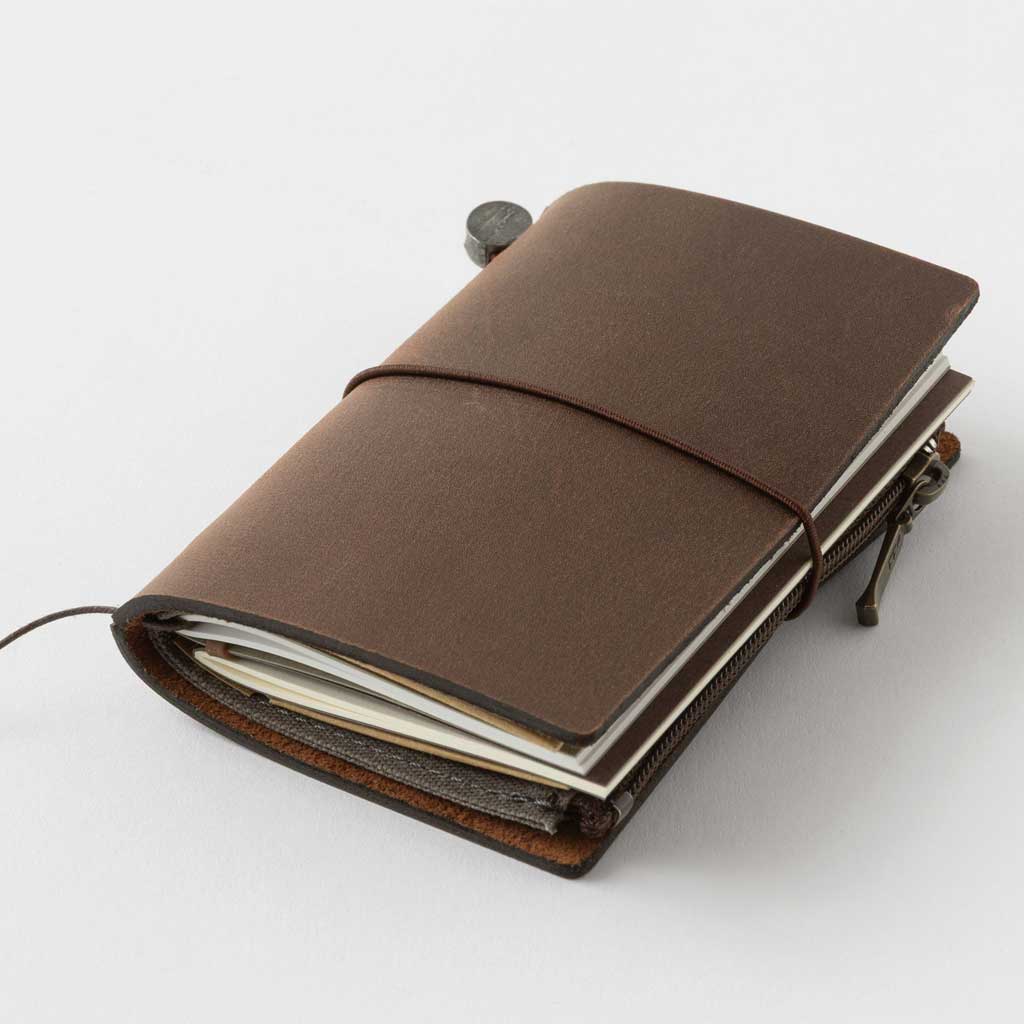 Brown Card-size notebook closed on light background