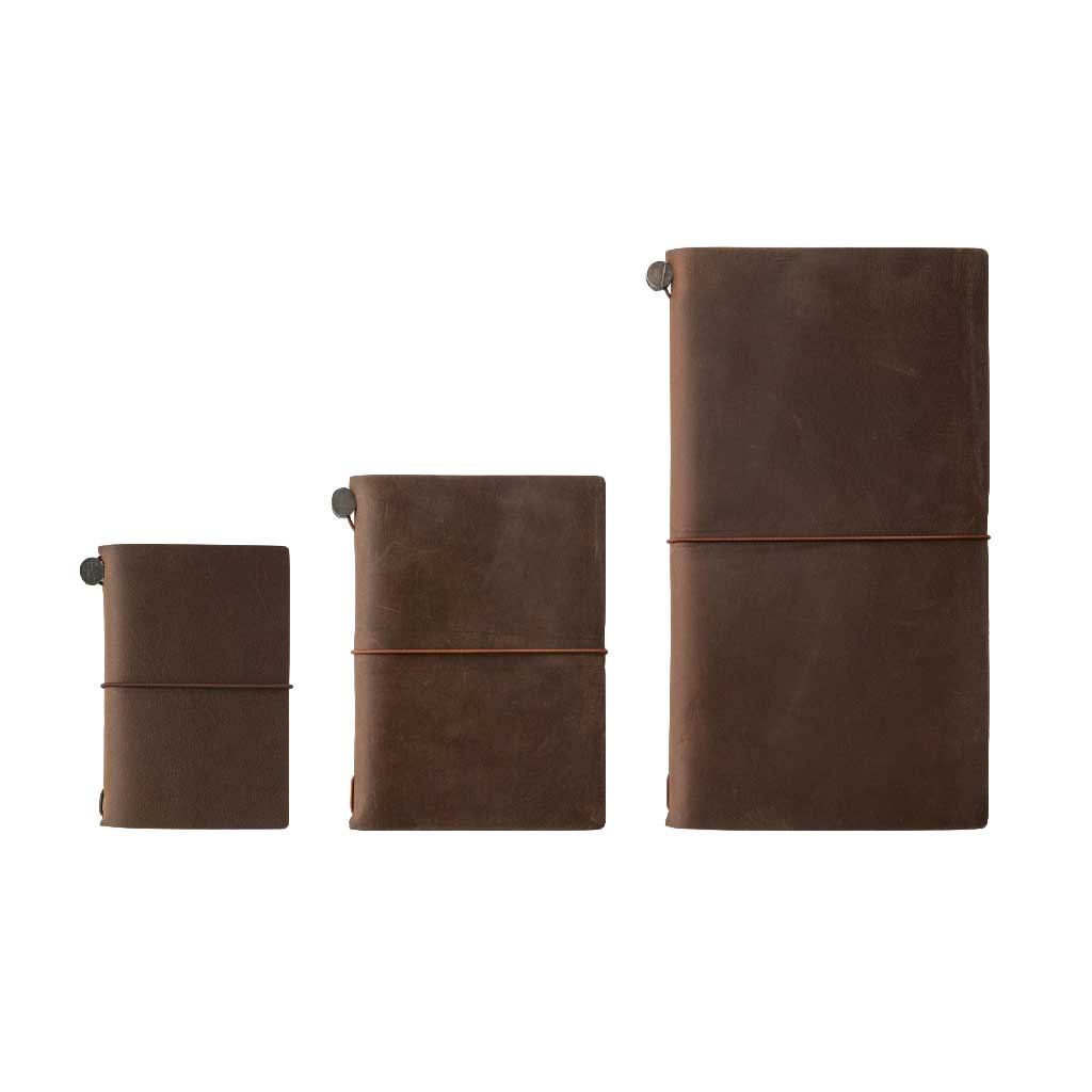Three traveler's notebooks on white background to show scale. Card-size, then passport, then regular.