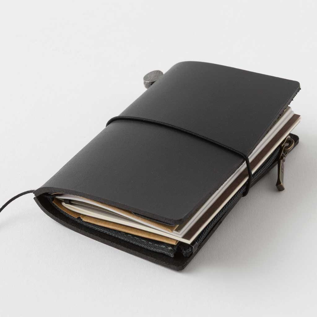 Black Card-size notebook closed on light background