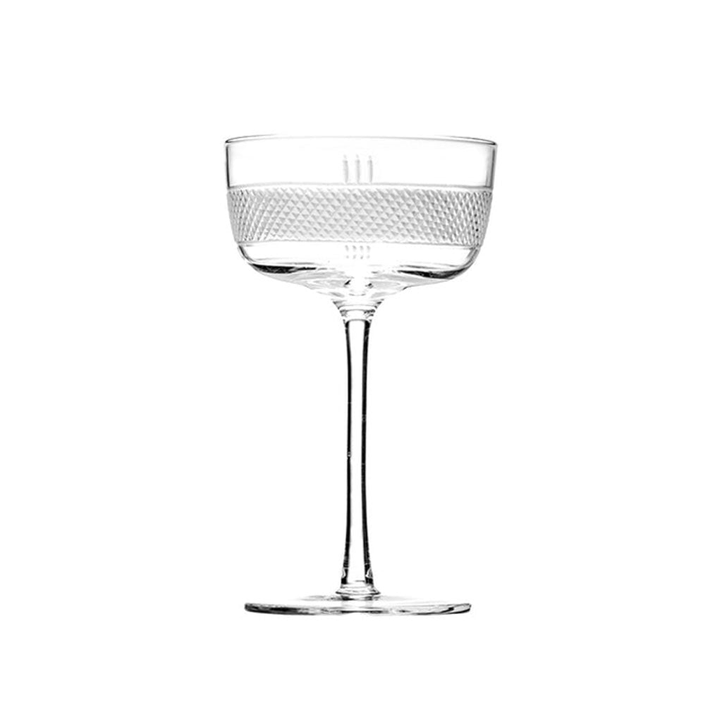 Clear stemmed glass cocktail glass with textured rim on a white background