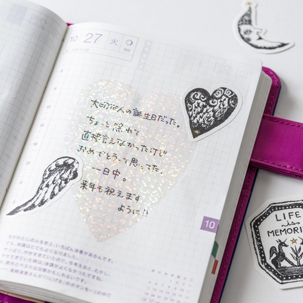 Open Hobonichi notebook with three not a dream stickers on page