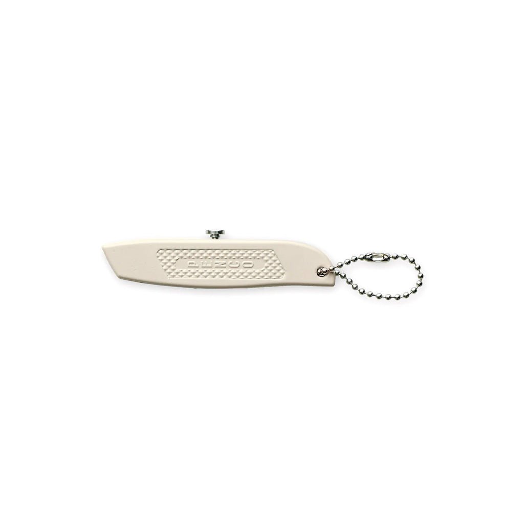 Beige steel mini utility knife with silver hardware on white background