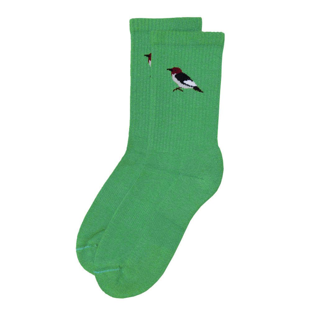 green crew sock with a small embroidered woodpecker detail near the ankle