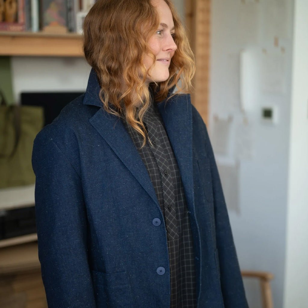 Woman wearing a blue coat in an indoor setting