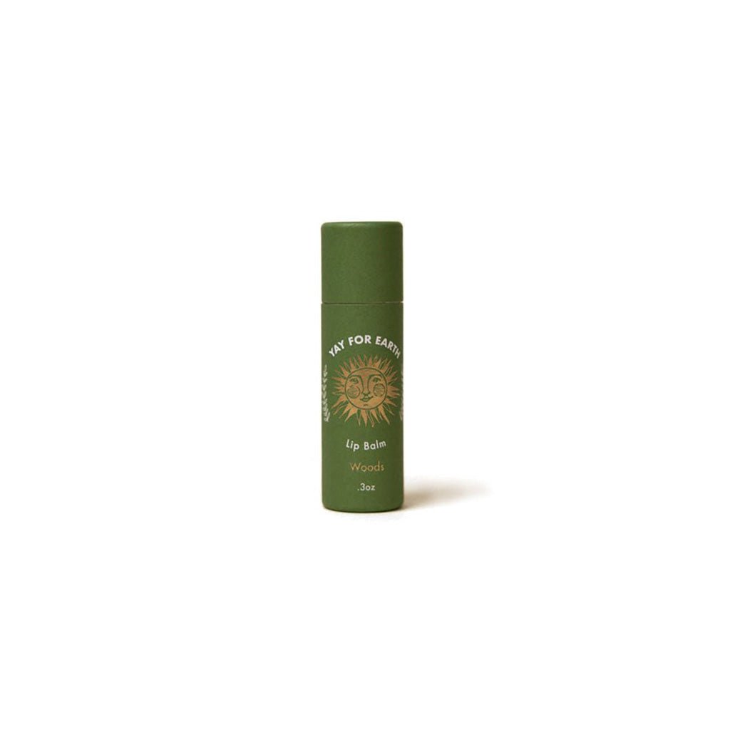 Green Woods lip balm tube with brand logo on a white background